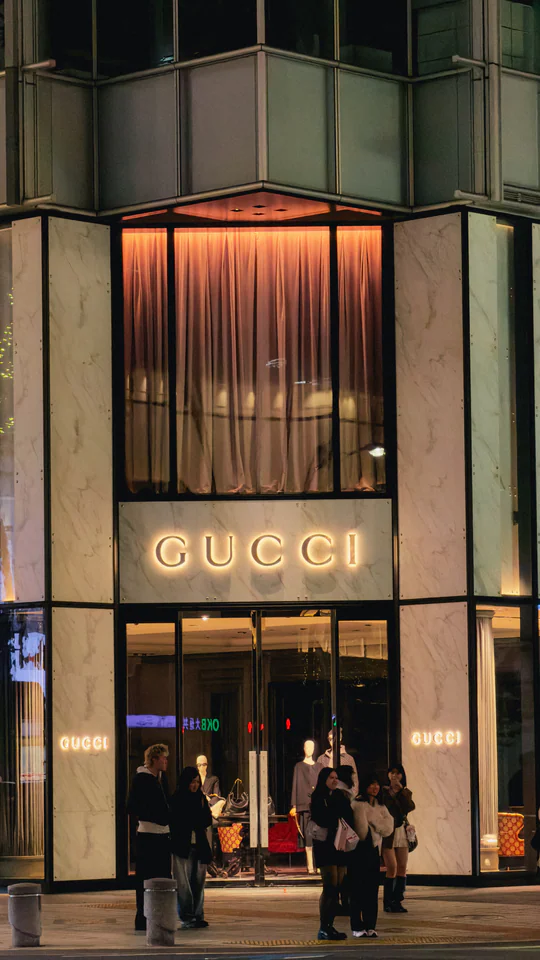 Elegant Gucci storefront in Tokyo, Japan, illuminated at night. Featuring modern architecture and luxury fashion.