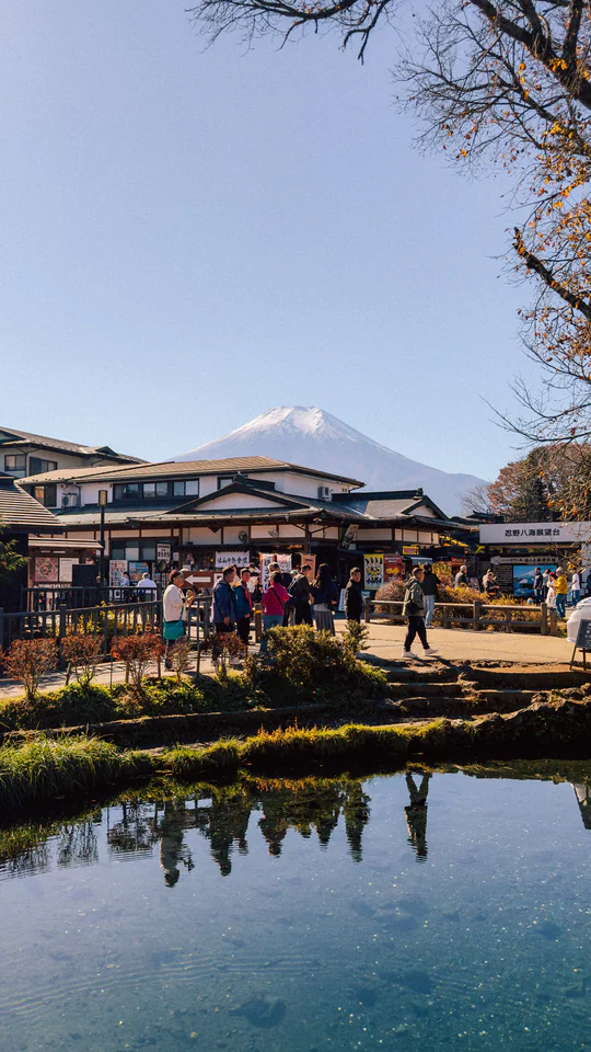 Visitors enjoying the scenic view of Mount Fuji from Oshino Hakkai village in Japan.