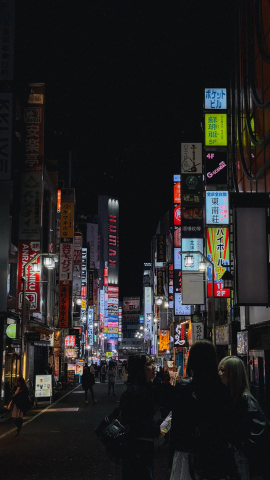 Experience Tokyo's vibrant nightlife with bustling streets full of neon lights and diverse crowds.